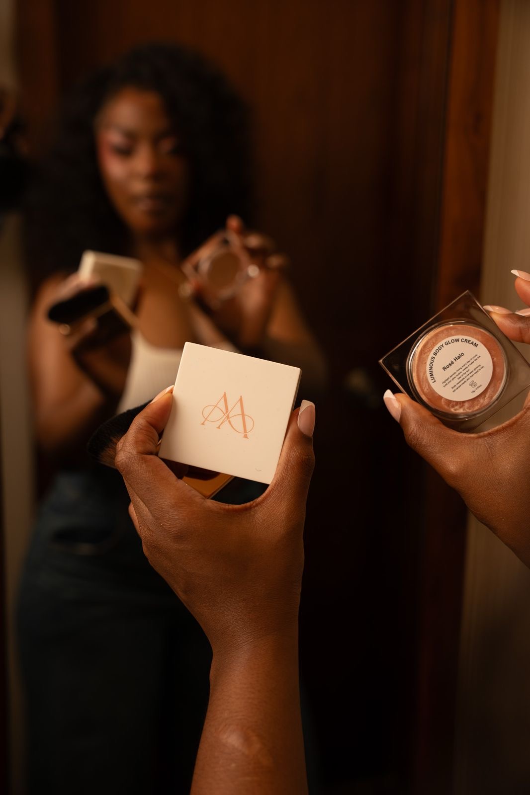 ALMA Luminous Body Glow Cream in Rosé Halo beside its monogram compact