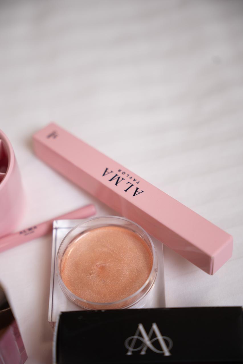 ALMA Body Glow Cream in a clear jar with a golden shimmer