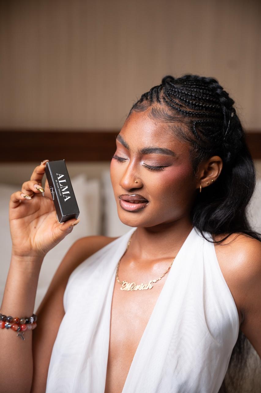 Model holding the black ALMA lipstick box